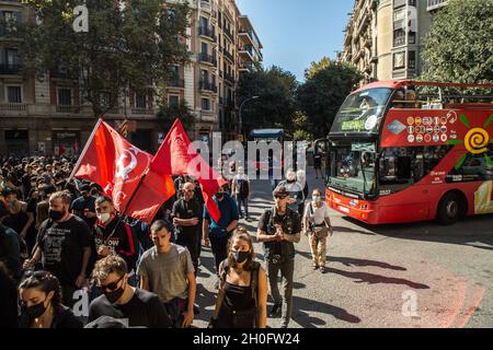 Barcelona, Katalonien, Spanien. Oktober 2021. Vor den Bussen werden Demonstranten gesehen, die die Straße durchschneiden.rund 400 Menschen aus antifaschistischen Gruppen haben eine Demonstration gegen die Ereignisse des 12. Oktober, dem Hispanic Day in Barcelona, aufgerufen. Die Demonstranten sind in die Richtung einiger dieser Handlungen gegangen, aber die Polizei hat sie bei allen Gelegenheiten verhindert. (Bild: © Thiago Prudencio/DAX via ZUMA Press Wire) Stockfoto