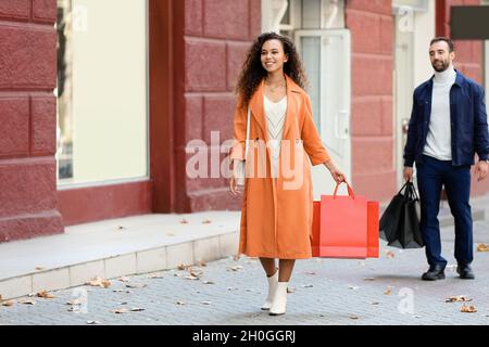 Junge Frau mit Einkaufstüten auf Stadt. Stockfoto