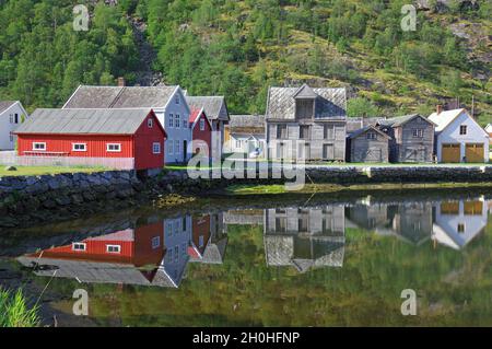 Alte Holzhäuser im stillen Wasser, hohe Berge, Laerdalsoyri, Innlandet, Sognefjord, Skandinavien, Norwegen Stockfoto