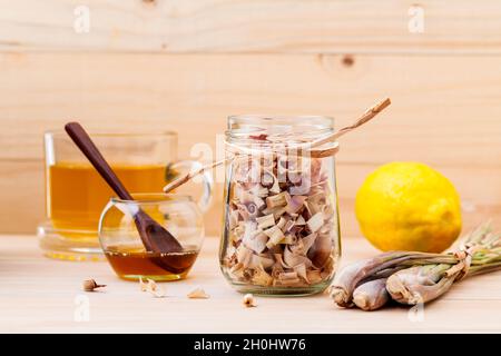 Tasse Kräutertee mit getrockneten Lemon Grass, Honig und Zitrone auf Holz- Hintergrund. Stockfoto