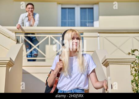 Mutter und Tochter eine Studentin auf der Veranda des Hauses in der Nähe der Eingangstür Stockfoto