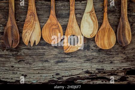 Verschiedene Holz- und Kochutensilien. Holzlöffel und Holzspachtel auf schäbige Holz- Hintergrund mit Flach Platz und zu kopieren. Stockfoto