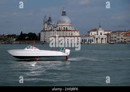 Ein komplett elektrisches Boot, die Candela, fliegt während der Venice Boat Show im Arsenale am Eröffnungstag der Ausgabe 2021 auf Ju über das Wasser Stockfoto