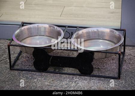 Zwei Wasserschüsseln für Hunde vor dem Laden Stockfoto