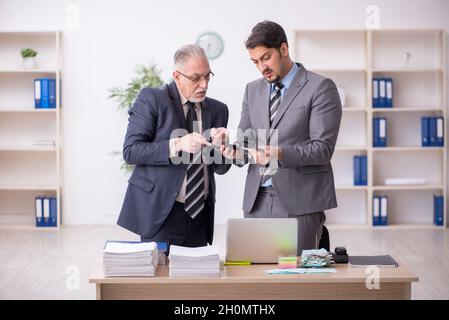 Zwei männliche Buchhalter im Budgetplanungskonzept am Arbeitsplatz Stockfoto