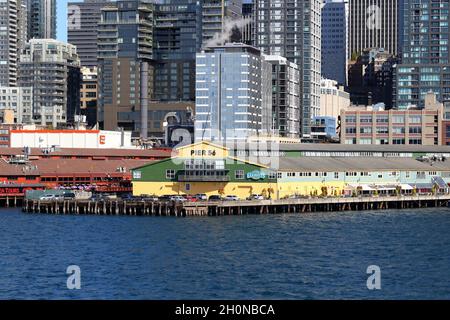 Seattle Pier 54 im Puget Sound mit Gebäuden des Central Business District im Hintergrund. Stockfoto