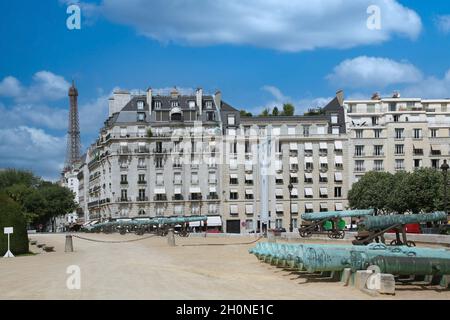 Paris, historische Kanonen im Freien im Militärmuseum, vor eleganten Wohngebäuden Stockfoto