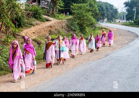 HSIPAW, MYANMAR - 1. DEZEMBER 2016: Junge buddhistische Nonnen gehen in einem Dorf in der Nähe von Hsipaw, Myanmar, zur Almosen Stockfoto