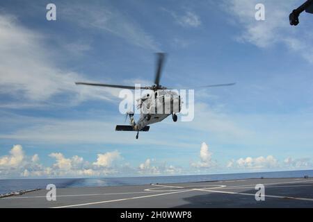 PHILIPPINISCHES MEER, 19. September 2021- Ein MH-60s, das an das Hubschrauber-Seekampfgeschwader (HSC) 25 angeschlossen ist, landet auf HMNZZ Aotearoa, um eine medizinische Evakuierung zu unterstützen. HSC 25 ist das einzige forward-deployed Expeditions-Geschwader der Marine MH-60S und unterhält eine 24-stündige Such- und Rettungs- sowie medizinische Evakuierungsalizierung in Guam, die die US-Küstenwache und die Joint Region Marianas direkt unterstützt, um die Sicherheit im Einsatzgebiet der 7. Flotte der USA zu gewährleisten. HSC 25 ist das einzige forward-deployed Expeditionsgeschwader der Marine MH-60S (mit freundlicher Genehmigung der Royal New Zealand Navy) Stockfoto