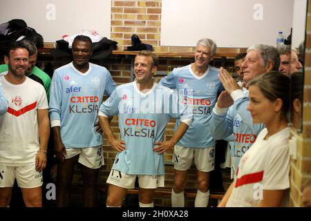 Poissy, Frankreich. Oktober 2021. Präsident Emmanuel Macron, flankiert von Marcel Desailly und Arsene Wenger, in den Spinden vor einem Fußballspiel im Rahmen der Feier des fünfzigsten Jahrestages des „Varietes Club de France“ am 14. Oktober 2021 im Stadion Leo Lagrange in Poissy, am Stadtrand von Paris. Foto von Dominique Jacovides/Pool/ABACAPRESS.COM Quelle: Abaca Press/Alamy Live News Stockfoto