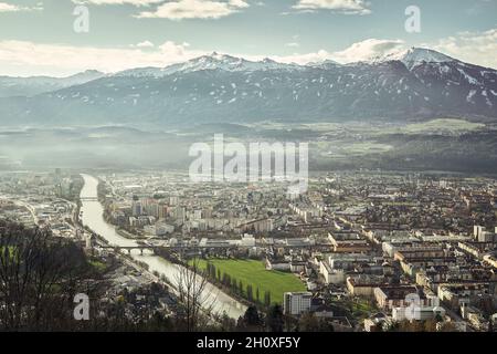 Blick auf die Stadt Innsbruck, neben dem Inn, mit einem großen Berg, dem Patscherkofel, im Hintergrund Stockfoto