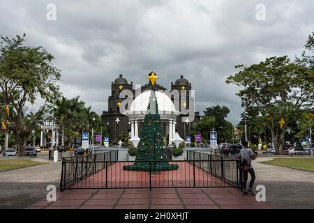 Weihnachtsbaum vor der weißen Kuppel und der schwarz bemalten Naga Kathedrale (Naga Metropolitan Kathedrale) während der Weihnachtszeit. Bicol Region, Philippinen Stockfoto