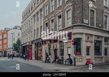 London, Großbritannien - 09. Oktober 2021: Reihe von Restaurants in einer Straße in Covent Garden, einem berühmten Touristenviertel in London mit vielen Geschäften und Restaurants, Peopl Stockfoto