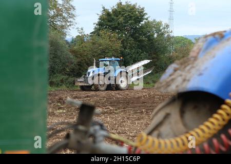 Blauer New Holland T7060 (2009) Traktor mit einem umkehrbaren 5 Furchen Pflug Stockfoto