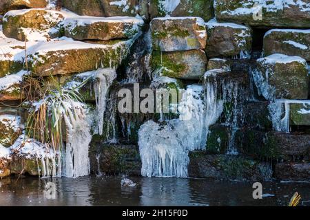 Kleiner eingelassener Wasserfall am Schloß Favorit im Winter Stockfoto