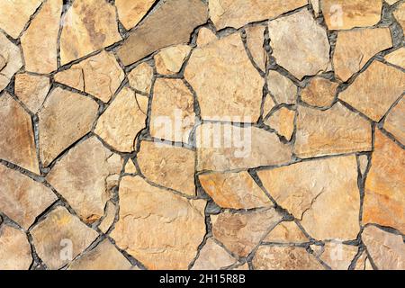 Fototextur von braunen Steinwandfliesen. Stockfoto