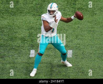 Miami Dolphins quarterback Tua Tagovailoa (1) is interviewed by CBS  reporter Aditi Kinkhabwala on the field after the Dolphins defeated the  Texans with a score of 30-15 during an NFL football game