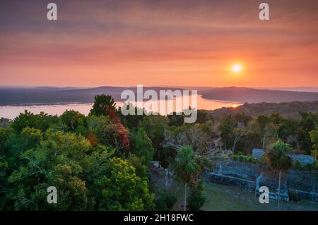 Ein Blick auf den Sonnenuntergang über dem Lake Yaxha, vom Tempel 216. Lake Yaxha, Tikal National Park, El Peten, Guatemala. Stockfoto