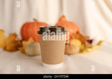 Kaffee Take Away Tasse im Herbst Kürbis aufgestellt. Kürbis-Latte mit Schlagsahne und frischem Zimt würzen. Kaffee zum trinken Stockfoto