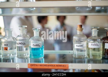 Flaschen mit verschiedenen Chemikalien auf dem Regal in einer sterilen Laborumgebung. Wissenschaft, Chemie, Labor, Menschen Stockfoto