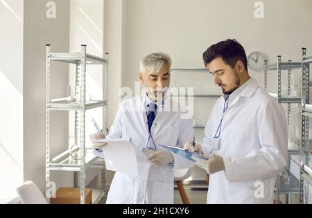 Wissenschaftlicher Laborleiter und Assistent diskutieren gemeinsam die Ergebnisse der Experimente Stockfoto