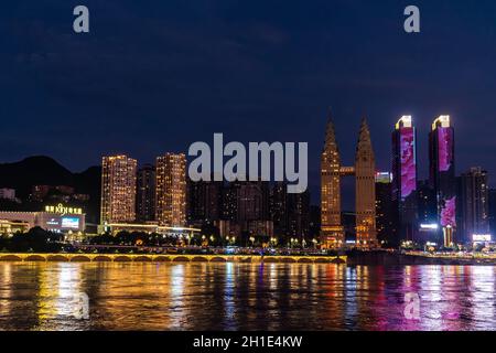 Chongqing, China - August 2019 : Nachtsicht auf die Stadt Chongqing beleuchtet Jialing und Yangtze mit beleuchteten Wolkenkratzern im Hintergrund Stockfoto