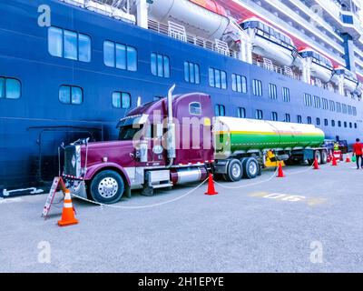 Puerto Limon, Costa Rica - 9. Dezember 2019: Die Truck-Zisterne betankt ein Kreuzfahrtschiff Holland America Kreuzfahrtschiff Eurodam, das in Puerto Limon in C angedockt ist Stockfoto