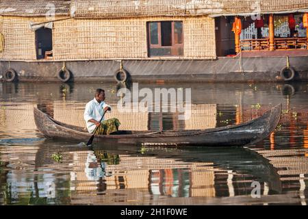 KERALA, INDIEN - 5. MAI 2010: Nicht identifizierter indischer Mann in einem kleinen Boot in Backwaters. Kerala Backwaters sind sowohl große Touristenattraktion als auch integraler Par Stockfoto