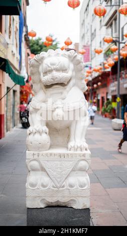 Portraitbild einer chinesischen Steinstatue eines Drachens in der chinatown Gasse Stockfoto