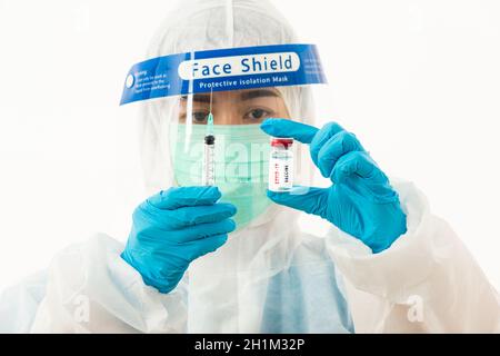 Frau medizinische Wissenschaftlerin in PSA Uniform trägt eine Gesichtsmaske Schutzschild aus Kunststoff für Impfstoff und Spritze Quarantäne Coronavirus o Stockfoto