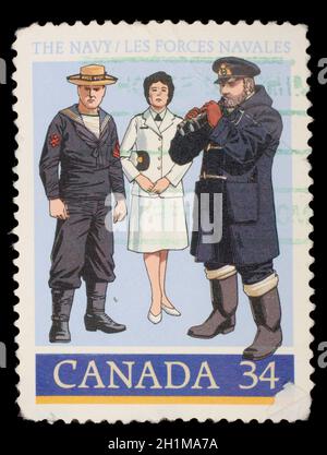 Die von Kanada gedruckte Briefmarke zeigt 1910 Gunner's Mate, Offizier des Zweiten Weltkriegs, um 1985 Stockfoto