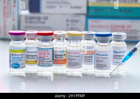 Calgary, Alberta. Kanada. Januar 31, 2021. Mehrere covid-19-Impfstoffmarken auf Fläschchen mit einer Spritze. Stockfoto