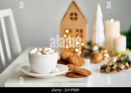 Gemütliche Abendszene im Winter. Weihnachten Urlaub Hintergrund mit Tannenzweig, Tasse heißen Kakao Stockfoto