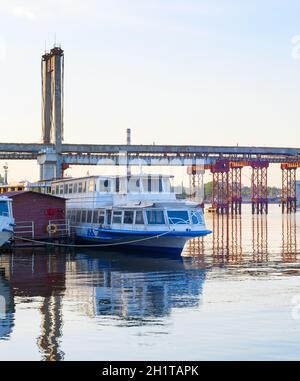 Verlassene alte Brücke über den Fluss Dnipro. Altes sowjetisches Passagierboot. Kiew, Ukraine Stockfoto