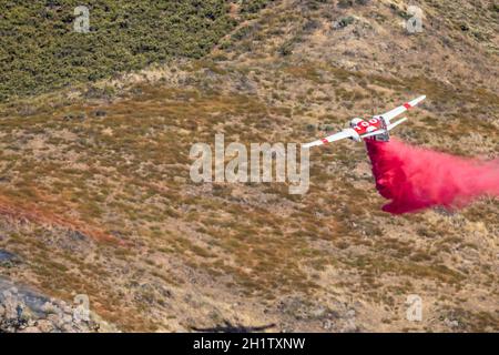 Winchester, CA USA - 14. Juni 2020: CAL Fire Aircraft fällt feuerhemmend auf einem trockenen Waldbrand auf einem Hügel in der Nähe von Winchester, Kalifornien. Stockfoto