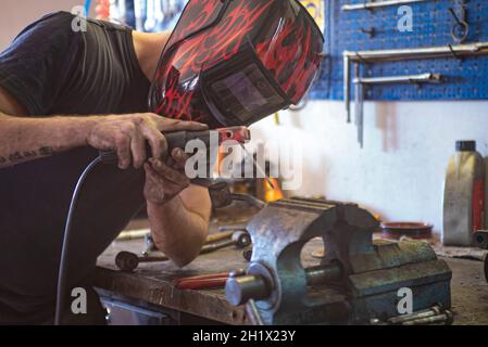 Detail von man schweißt Metall in einer Werkstatt Stockfoto