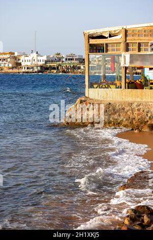 Dahab, Ägypten - 10. September 2021: Küste am Roten Meer, Blick auf den Sandstrand und den Boulevard mit Restaurants und Hotels. Dahad ist ein ehemaliger Beduinenvil Stockfoto