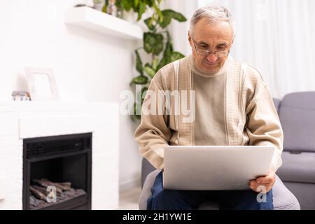 Senior, der an einem Laptop arbeitet, älterer Mann. Stockfoto