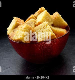 Maisbrot in einer Schüssel in Würfel schneiden Stockfoto