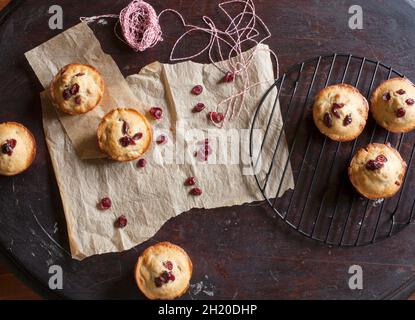 Frisch gebackene Cranberry Muffins kühlen auf Gestell und Pergamentpapier Stockfoto