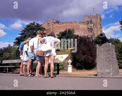 Blick auf das normannische Schloss mit Touristen, die im Vordergrund eine Informationstafel lesen, Tamworth, Staffordshire, England, Großbritannien, Westeuropa. Stockfoto