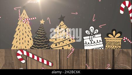 Bild von Schnee und Zuckerstöcken fallen über weihnachtsbäume und Geschenke auf schwarzem Hintergrund Stockfoto
