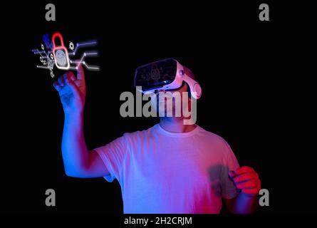 Junger Mann macht sichere Anmeldung mit Fingerabdruck mit virtueller Brille. Neue sichere Technologie Blockchain Stockfoto