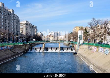 Bukarest, Rumänien, 13. Februar 2021 - kleine Brücke, alte Gebäude in der Nähe des Flusses Dambovita und klarer blauer Himmel im Zentrum von Bukarest, Rumänien, in einer s Stockfoto