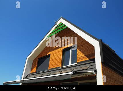 Modernes Haus Von Außen. Neues Gebäude Haus Energieeffizienz Lösungskonzept Outdoor. Solarenergie, Sonnenkollektoren, installiert auf Bitumen gekachelt RO Stockfoto