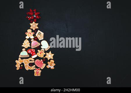 Weihnachtsbaum aus Lebkuchen und Gewürzen auf dunklem Grund. Speicherplatz kopieren. Neujahrs- und Weihnachtskarte. Stockfoto