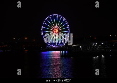 Regenbogen-Riesenrad auf dem Wasser Stockfoto