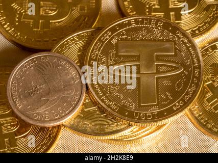 Konzept der Tethermünze gegen goldene Bitcoin-Münzen und eine einzelne US-Dollar-Münze. Tether wird durch US-Dollar unterstützt und für den Handel mit alt-Münzen verwendet Stockfoto