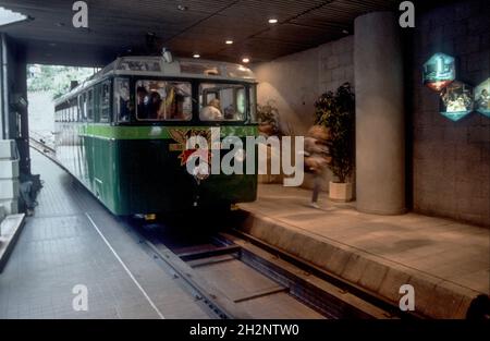 Die 1956 Peak Tram, die in den 1980er Jahren auf der Garden Road Station, Hong Kong Island, China, ankommt Stockfoto