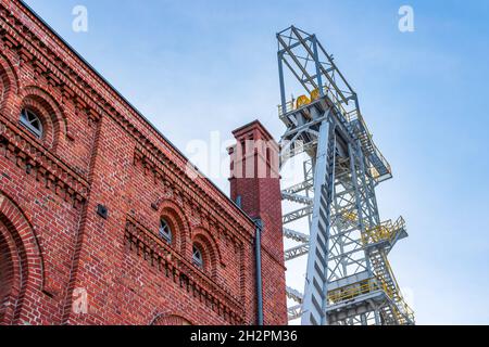 Der Schachtturm der Mine Krystyn im ehemaligen Kohlebergwerk Michal in Siemianowice, Schlesien, Polen gegen blauen Himmel. Historisches, Backsteingebäude des Motors ro Stockfoto